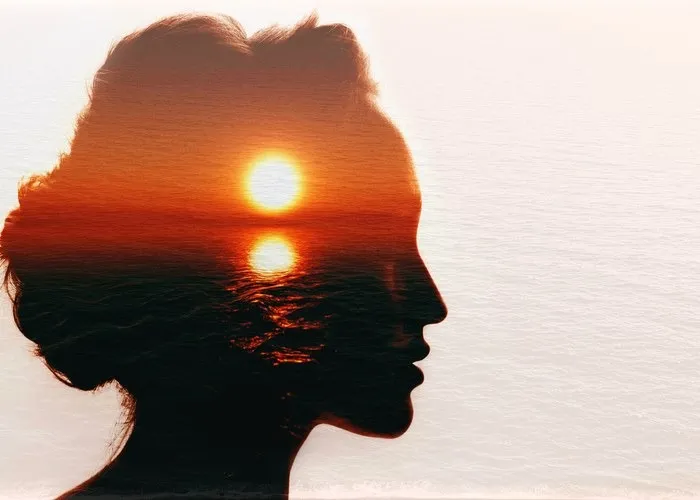 Conceptual double exposure. Sunrise in the woman head.